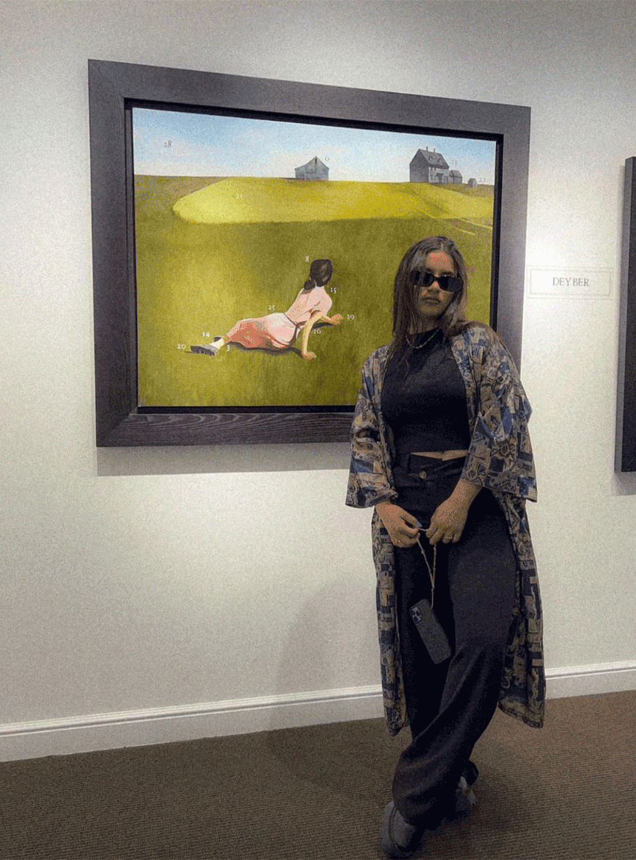 girl posing next to art