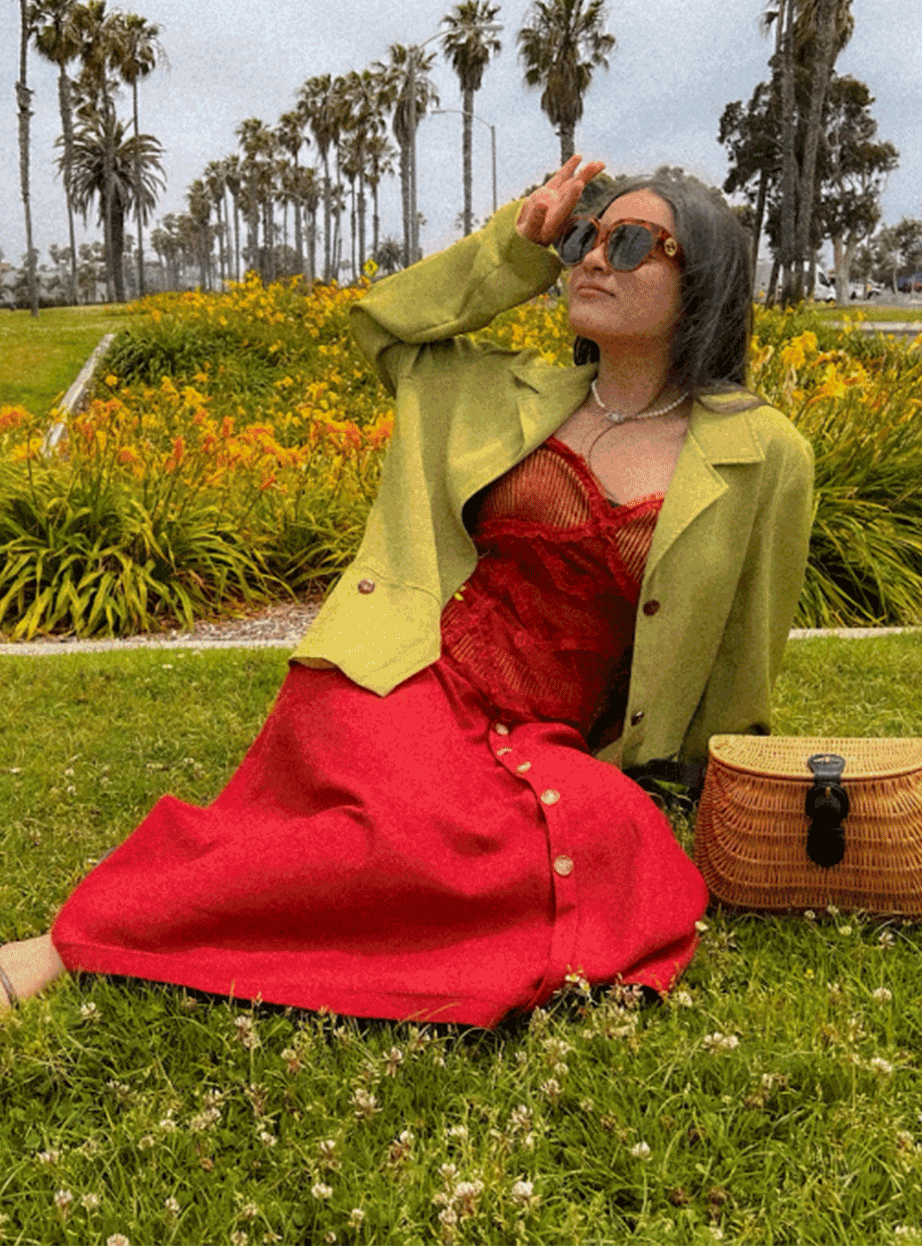 girl in red dress posing with flowers